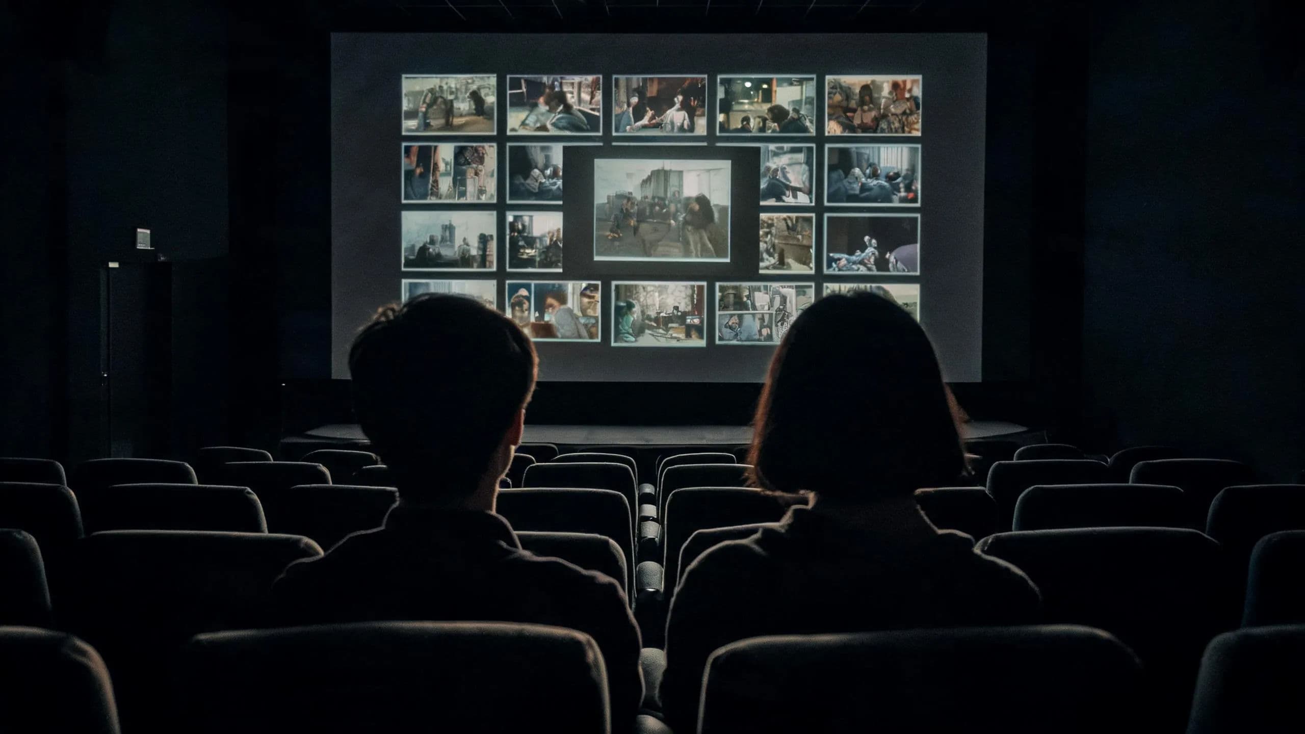 A screening room wall of projected dailies frames under review