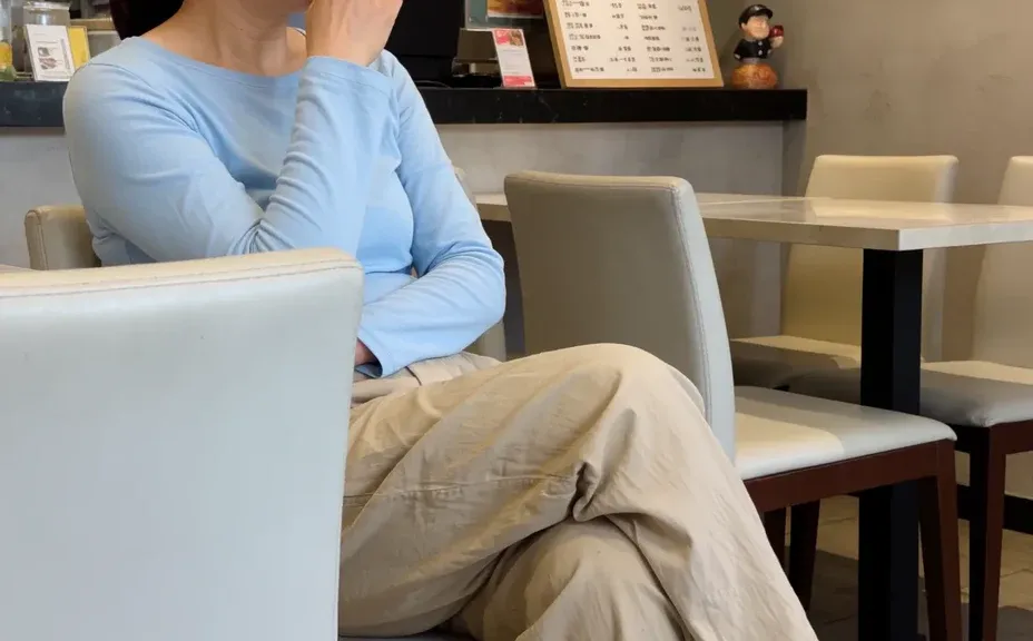 A plain, generic AI image of a woman in a cafe with flat lighting
