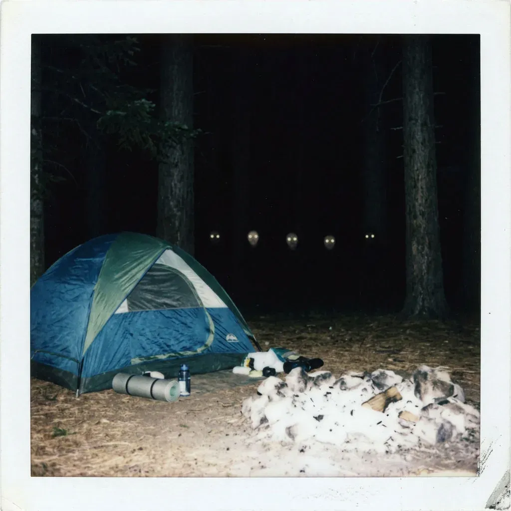 Instant photo of a flash-lit tent at night with several pairs of eyes reflecting in the trees beyond, generated with Nano Banana 2
