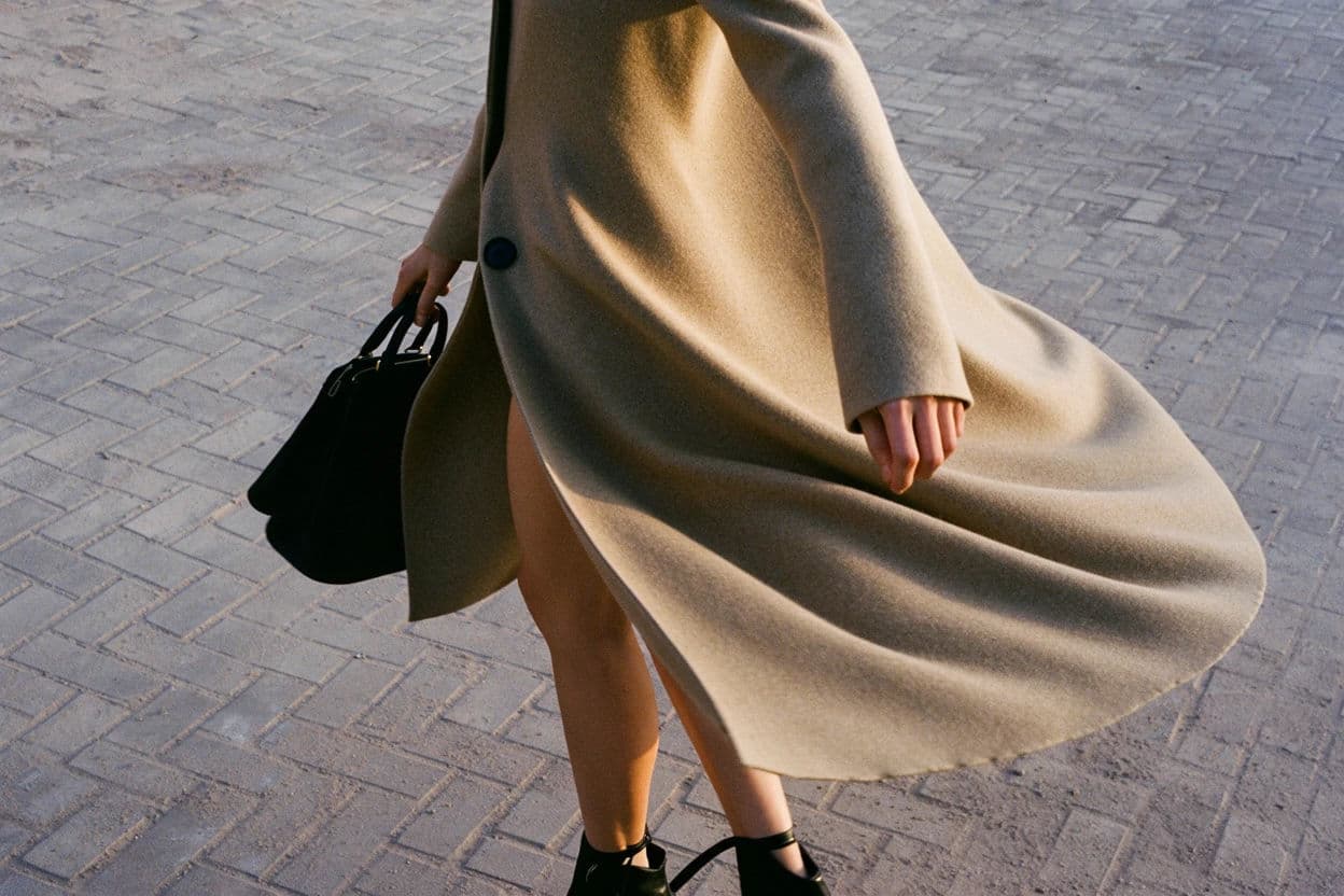 Fashion image capturing a model mid-movement with the coat still travelling, generated with Krea 2 Large