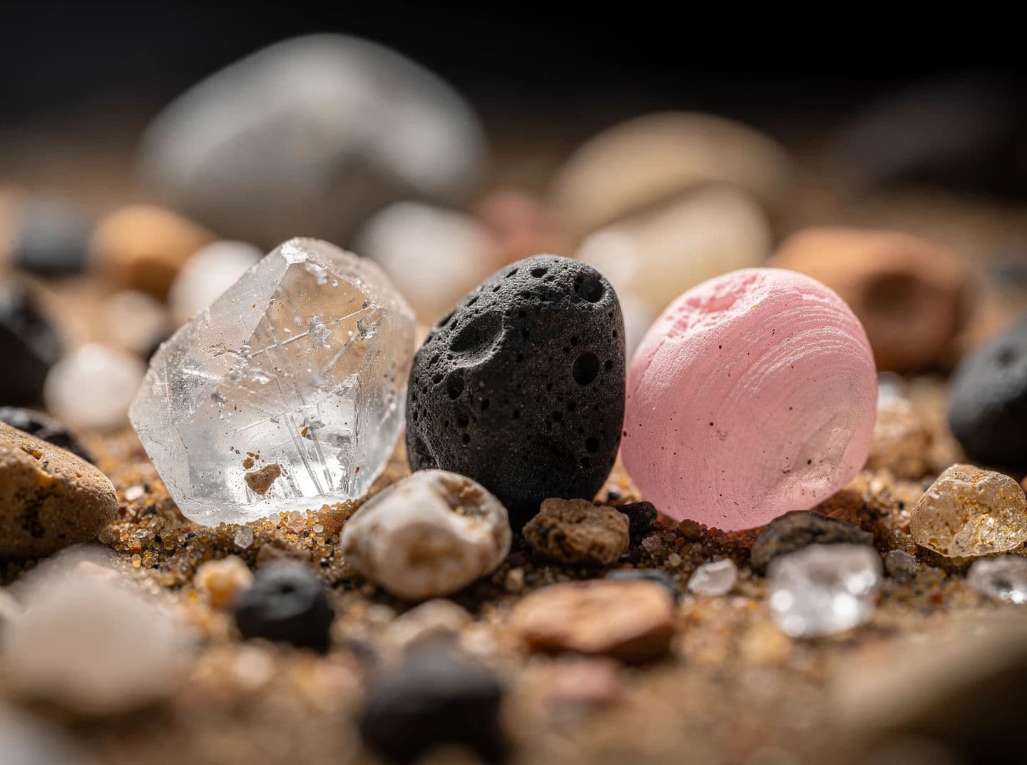 Macro photograph of individual sand grains showing they are different minerals and shapes, generated with Flux 2 Pro