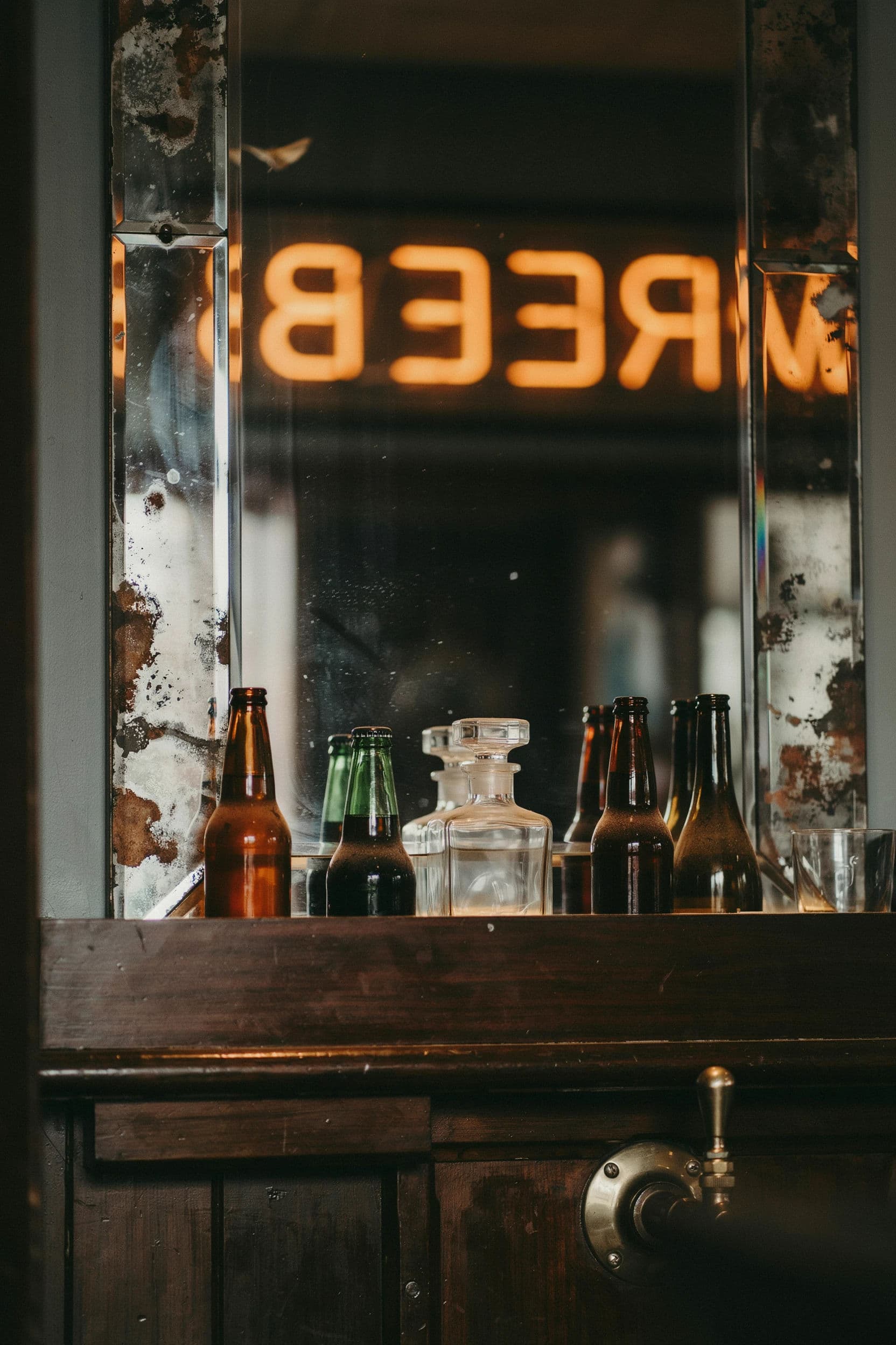 Vertical photograph of a bar mirror returning a reversed neon sign from the opposite wall, generated with Ideogram 4.0