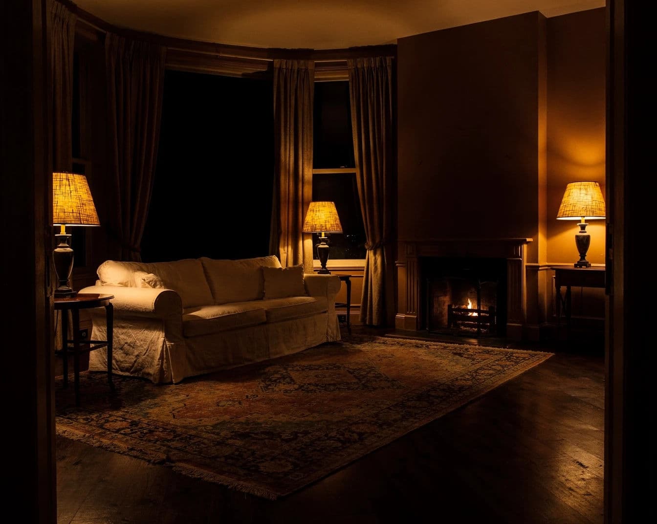 Listing photograph of a sitting room lit only by table lamps with dark space between the pools of light, generated with Flux 2 Pro