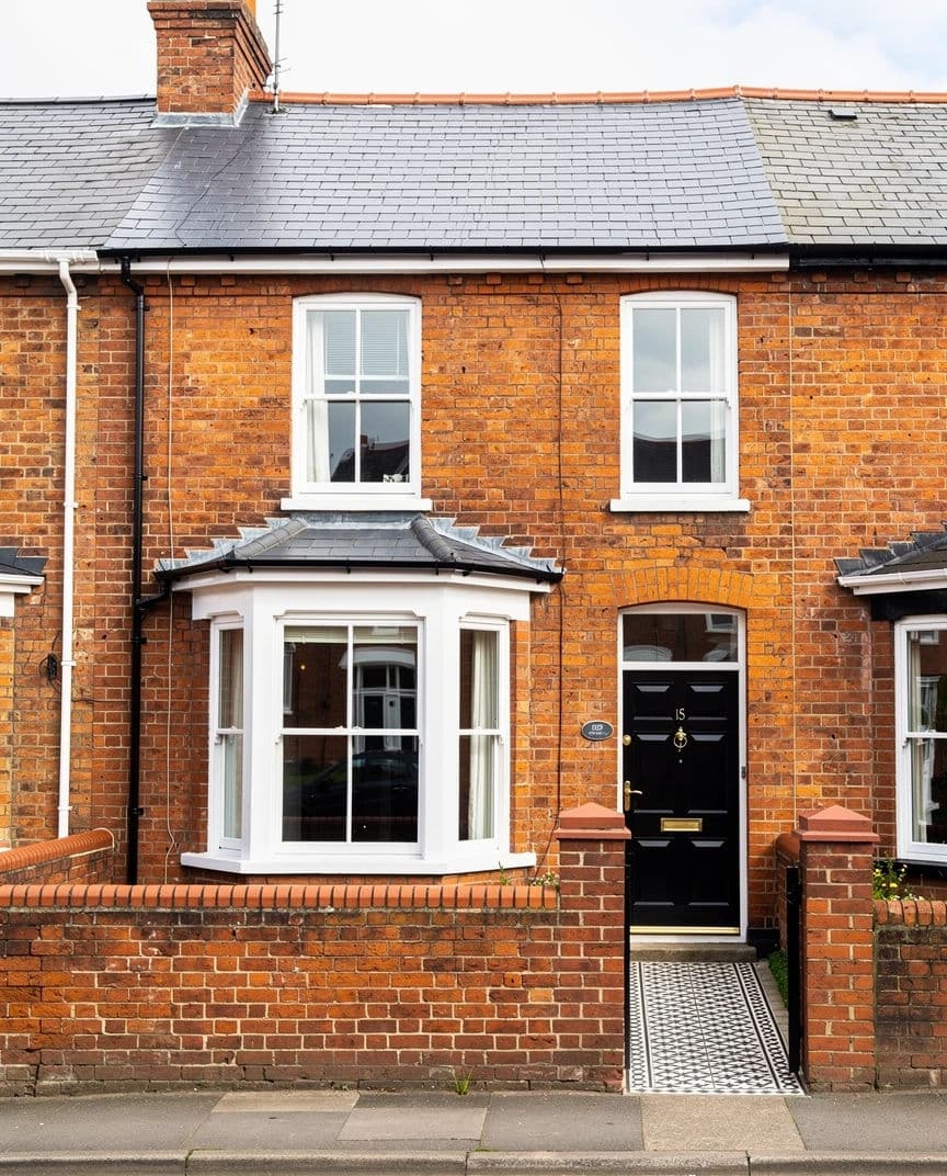 Listing photograph of a red brick Victorian terrace shot square on from the pavement, generated with Flux 2 Pro